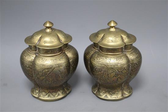 A pair of Chinese brass vases and covers, decorated with figures, cast seal marks to the bases, height 18cm